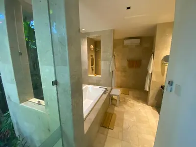 a large bathroom with a tub and a shower at Lotus Luxury Villa Seminyak in Seminyak