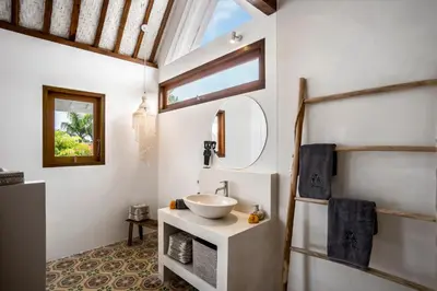 a bathroom with a sink and a mirror at Villa Mimpi Seminyak by Alfred in Bali in Seminyak