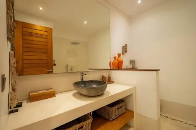 a bathroom with a bowl sink and a mirror at Flores Villa by Betterplace in Canggu