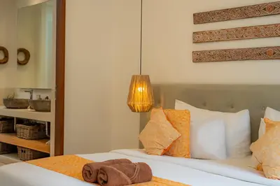 a bedroom with a bed with a towel on it at Flores Villa by Betterplace in Canggu
