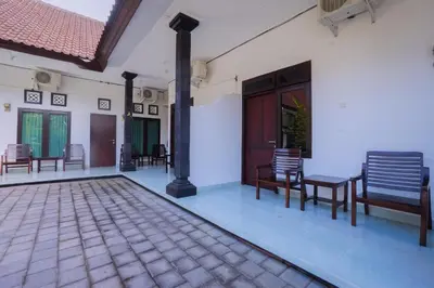 a patio with chairs and a table in a building at Kos Bulan Bali in Kuta