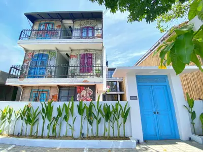 a building with a blue door and a fence at PAMELA BALI in Kerobokan