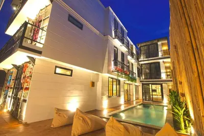 a building with a swimming pool in front of it at PAMELA BALI in Kerobokan