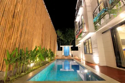 a swimming pool in the middle of a building at PAMELA BALI in Kerobokan