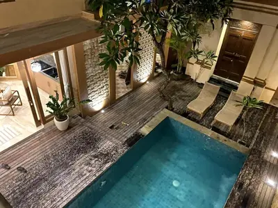 an indoor swimming pool in a house with plants at Cozy 3 Bedroom Villa in Seminyak in Seminyak