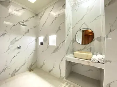 a white bathroom with a sink and a mirror at Cozy 3 Bedroom Villa in Seminyak in Seminyak