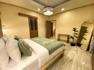 a bedroom with a large white bed with pillows at Cozy 3 Bedroom Villa in Seminyak in Seminyak
