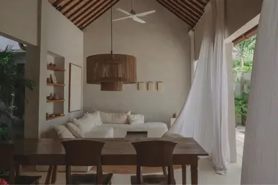 a living room with a table and a couch at Designer 3BR Villa Tropical Stay Near Canggu in Kerobokan