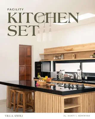 a kitchen with a black counter top and a kitchen sign at Villa Anoli - 3 chambres - Centre de Seminyak in Seminyak