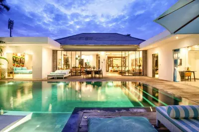 a house with a swimming pool in front of a house at Splendid Villa 3Br 200m to the Brawah beach in Canggu