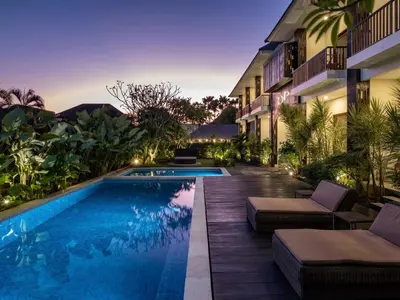 a swimming pool in front of a building at Cove Tevana in Seminyak