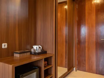 a room with wood paneling and a wooden closet at Cove Tevana in Seminyak