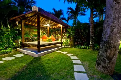 a gazebo in a garden at night at Villa Mango - 3 Bedroom Villa in Seminyak in Seminyak