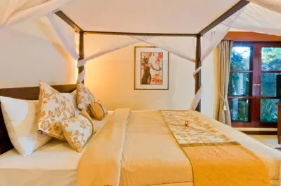 a bedroom with a bed with a canopy at Villa Mango - 3 Bedroom Villa in Seminyak in Seminyak