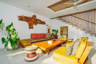 a living room with couches and a table at Villa Elyse Seminyak in Seminyak