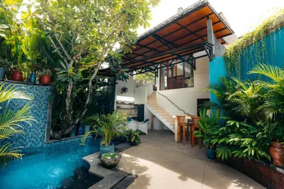a courtyard with a swimming pool in a house at Bali Adua Villa in Seminyak