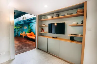 a room with a television and a living room at Bali Adua Villa in Seminyak