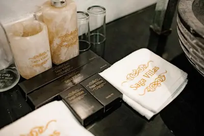 a table with two napkins and two candles on it at Saga Villas Oasis in Seminyak