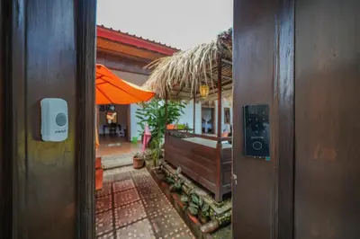 an open door to a house with an umbrella at Huge 2 Bedroom private pool Villa - Gong Zhu Camille in Pesanggaran