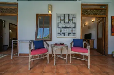 two chairs and a table in a room at Huge 2 Bedroom private pool Villa - Gong Zhu Camille in Pesanggaran