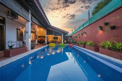 a swimming pool in a house with a sunset at Huge 2 Bedroom private pool Villa - Gong Zhu Camille in Pesanggaran