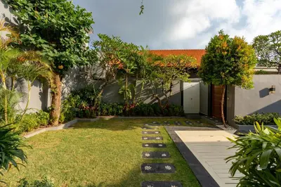 a backyard with a garden with a lawn sidx sidx sidx sidx at Vast 5bd Villa with Garden and Private Pool 250m to Beach in Seminyak