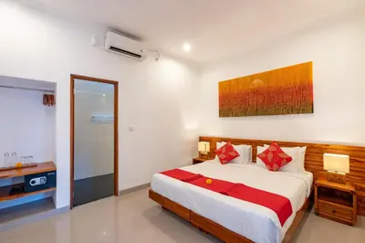 a bedroom with a large bed with red pillows at Vast 5bd Villa with Garden and Private Pool 250m to Beach in Seminyak