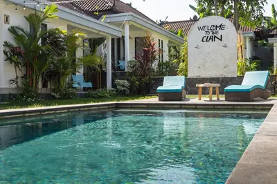 a swimming pool in front of a house at SHAKA CLAN SURF in Canggu