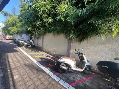a scooter parked next to a wall at SHAKA CLAN SURF in Canggu