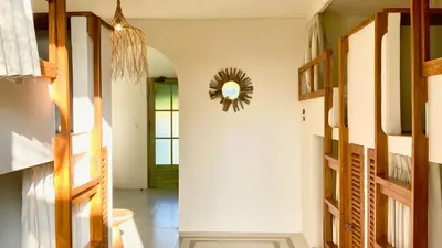 a room with a hallway with a mirror on the wall at White Penny Hostel in Seminyak