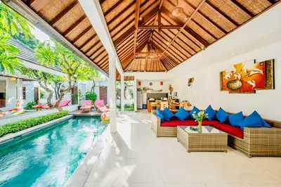 an open living room with a pool and a villa at Villa Olli in Seminyak