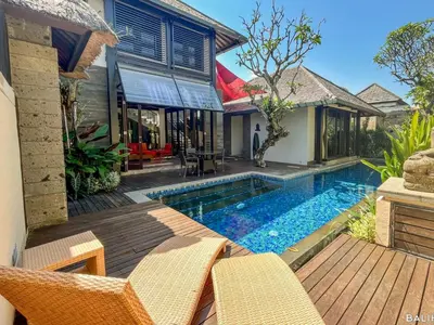 a backyard with a swimming pool and a house at Villa Canthy@Seminyak in Seminyak