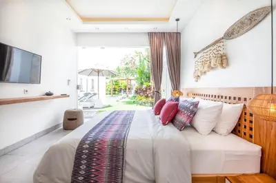 a bedroom with a large bed with red pillows at Luxurious 6 Br in Canggu 400m to Finns Beach in Canggu