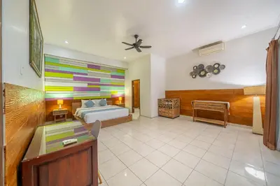 a bedroom with a bed and a colorful wall at Nameera Villa in Seminyak