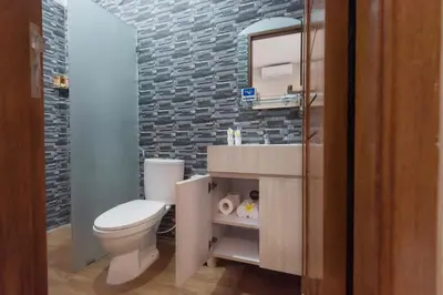a bathroom with a white toilet and a sink at Vpas Villa in Seminyak