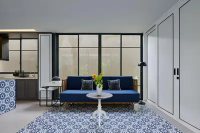 a living room with a blue couch and a table at New Luxury Villa Adamare 1 in Kerobokan