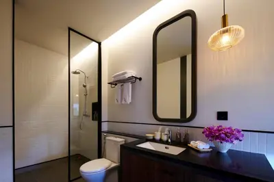 a bathroom with a sink and a toilet and a mirror at New Luxury Villa Adamare 1 in Kerobokan