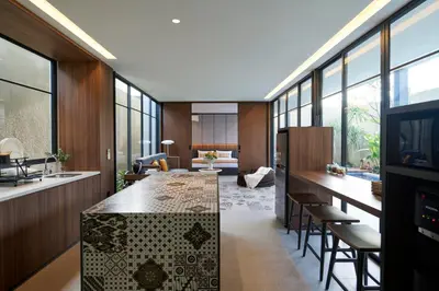 a kitchen with a large island in a room with windows at New Luxury Villa Adamare 1 in Kerobokan