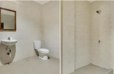 a bathroom with a toilet and a sink at Moreno Homestay in Legian