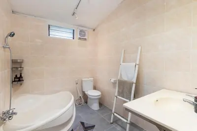 a bathroom with a sink and a toilet and a tub at Villa Burung in Kashantee Village in Seminyak