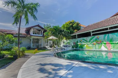 a swimming pool in the backyard of a house at Villa Burung in Kashantee Village in Seminyak