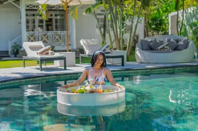 a woman is in an inflatable at Villa Burung in Kashantee Village in Seminyak