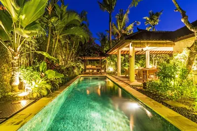 a swimming pool in a backyard with a gazebo at Baliani Beauty in Seminyak
