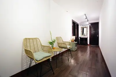 a living room with three chairs and a table at The Reward Villas in Seminyak