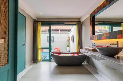 a bathroom with two sinks and a large tub at The Reward Villas in Seminyak