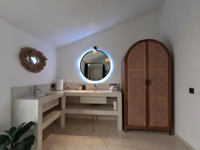 a bathroom with a sink and a mirror at Villa Curves Bali in Seminyak