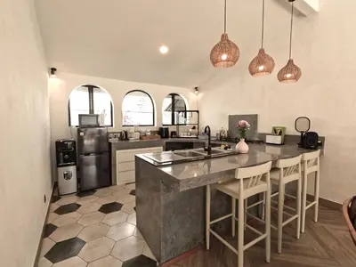 a kitchen with a large island in the middle at Villa Curves Bali in Seminyak
