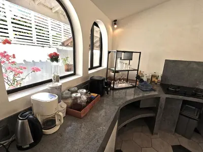 a kitchen with a counter with a coffee maker at Villa Curves Bali in Seminyak