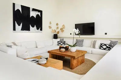 a living room with a white couch and a coffee table at Casa Umalas Villa by Betterplace in Canggu