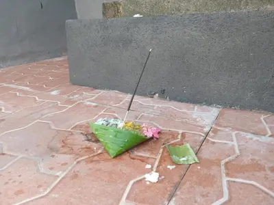 two umbrellas sitting on the ground on a sidewalk at 9 Residence's Seminyak in Seminyak